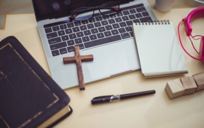 Cross necklace and employee ID badge on a desk to symbolize religious rights in the workplace.