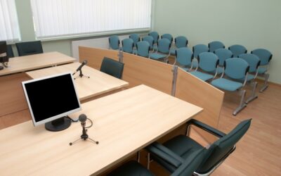 A courtroom jury box with empty chairs