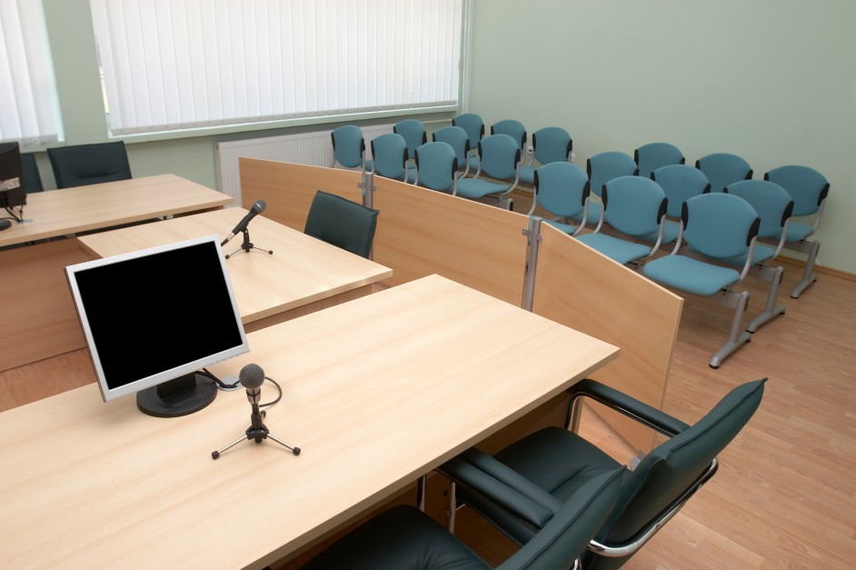A courtroom jury box with empty chairs