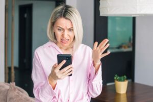Smartphone screen showing a heated social media rant with shocked emojis