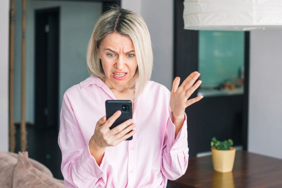 Smartphone screen showing a heated social media rant with shocked emojis