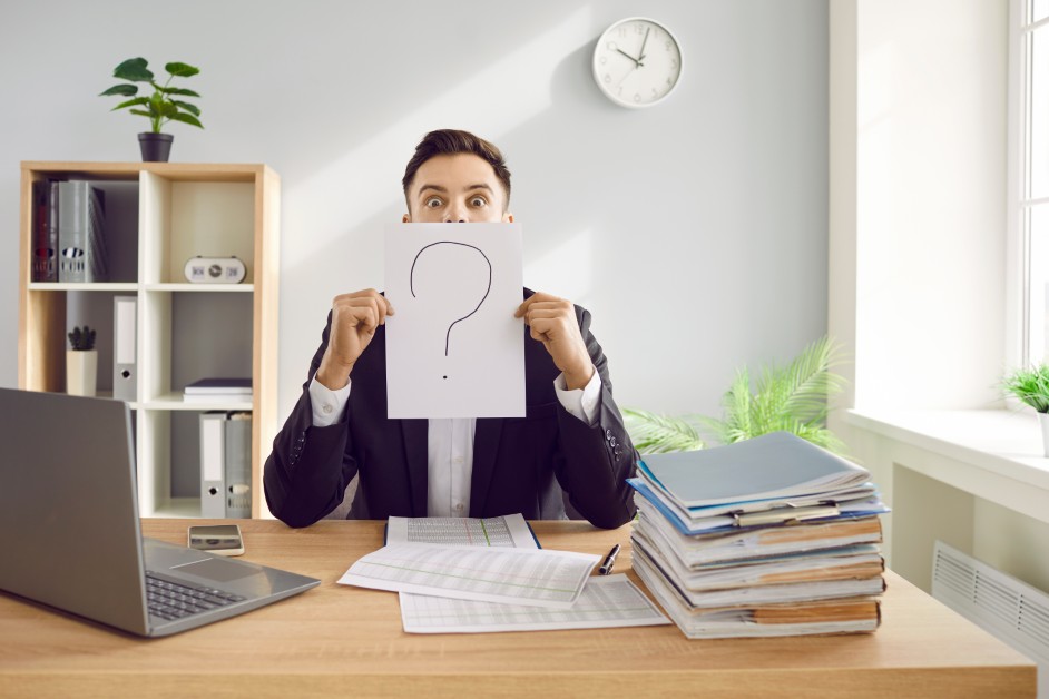 A confused employee looking at a jury verdict form with a red question mark overhead.