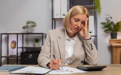Frustrated worker looking at paperwork after being wrongfully fired