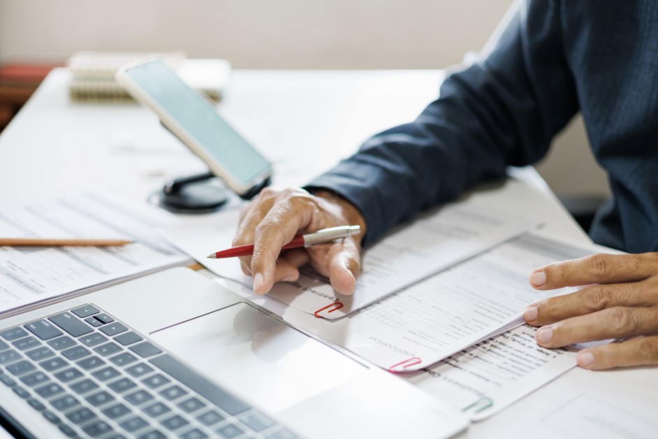 Employee reviewing documents while considering options after workplace discrimination.
