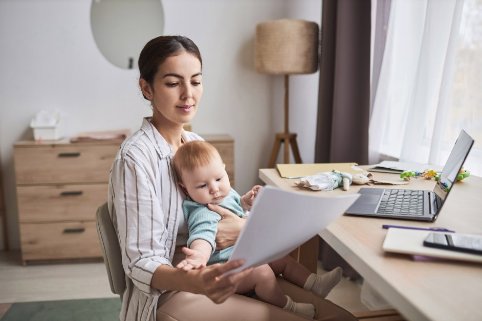 Parent reviewing workplace documents and calendar while worrying about a child’s medical treatment.