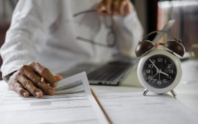 Employee reviewing overtime hours and pay records after suspected wage theft