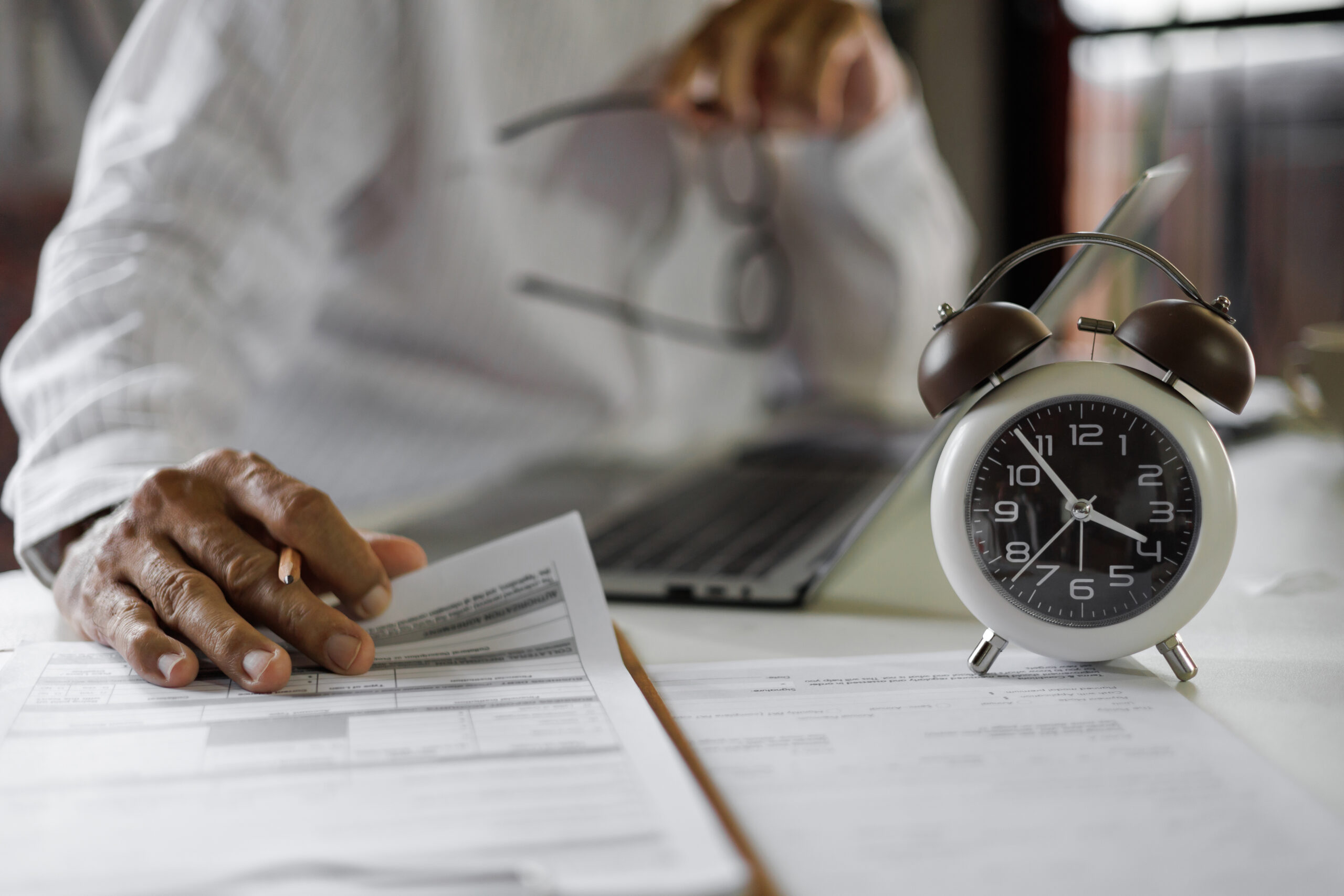 Employee reviewing overtime hours and pay records after suspected wage theft