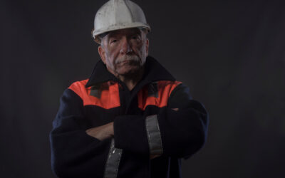 Industrial employee at underground tank site after employer denies safety equipment and disability accommodation.
