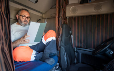 Truck driver reviewing paycheck after long hours without overtime pay