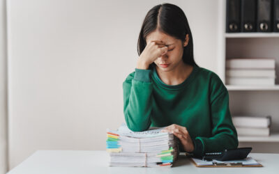 Employee frustrated reviewing legal documents after making a mistake in a legal case