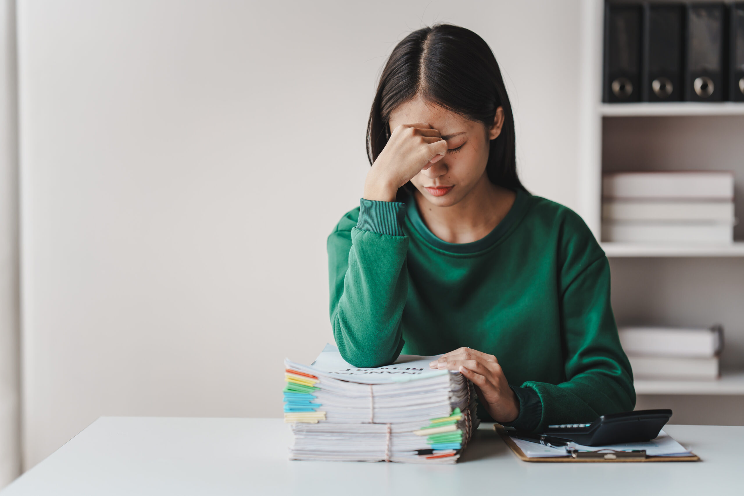 Employee frustrated reviewing legal documents after making a mistake in a legal case
