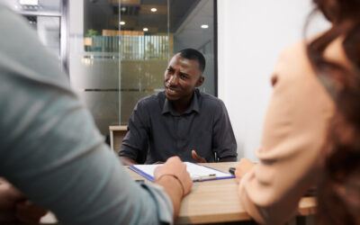 Black job applicant reacting to a rescinded job offer email with frustration and confusion