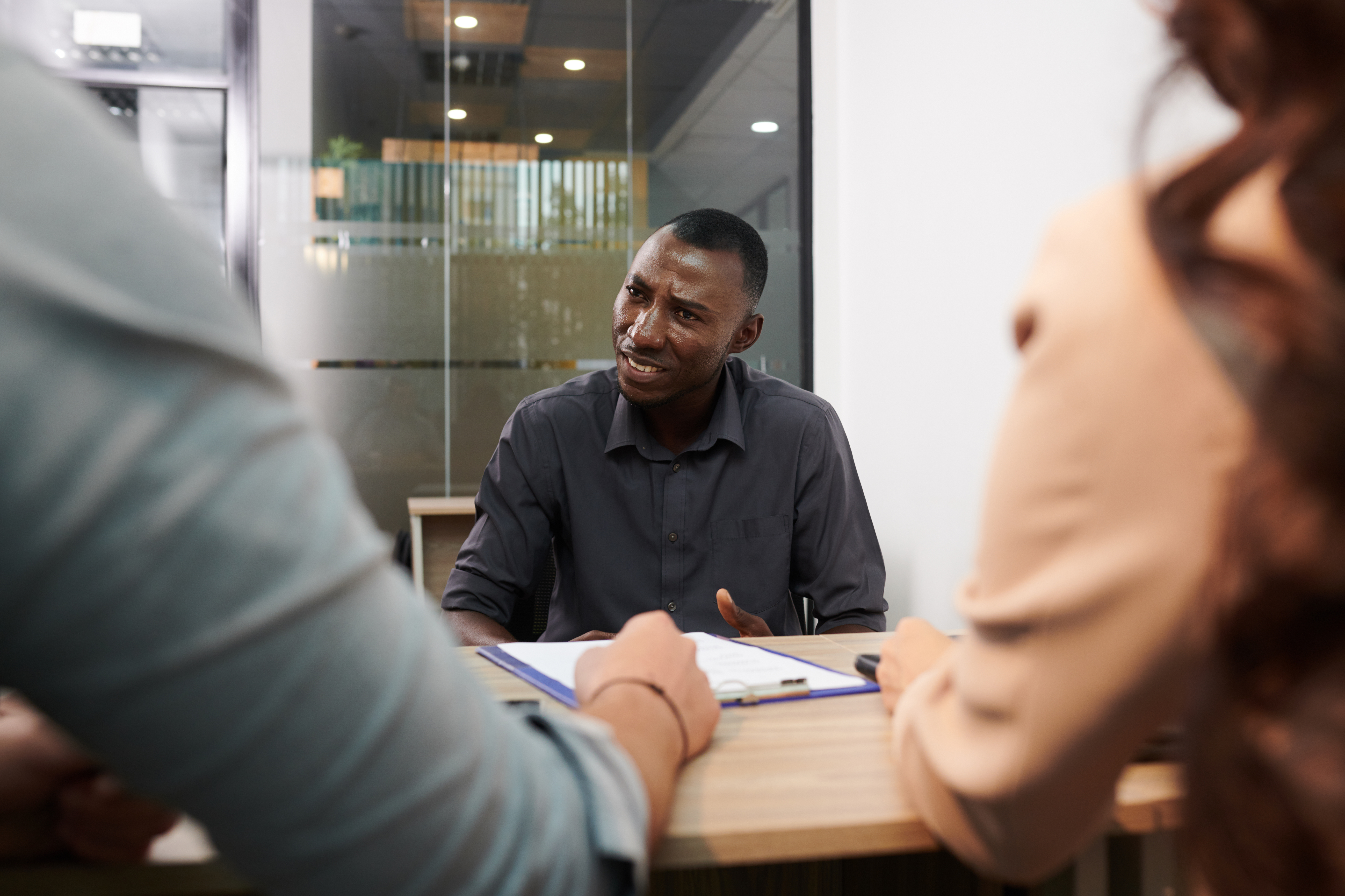 Black job applicant reacting to a rescinded job offer email with frustration and confusion