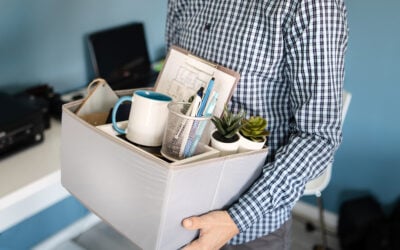 Employee reviewing termination notice, disability discrimination paperwork, EEOC charge deadline, and statute of limitations calendar.