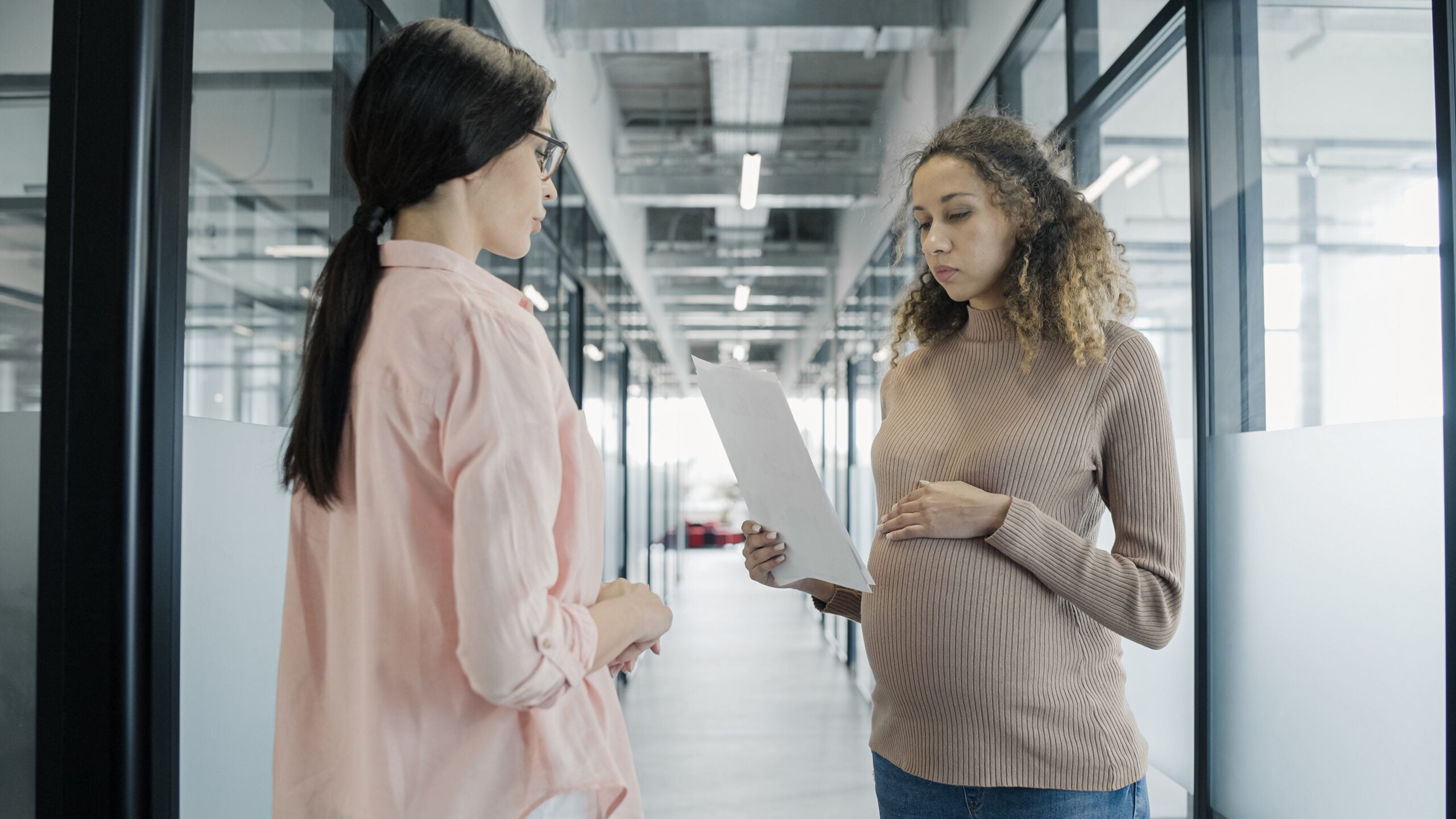 Employee reviewing FMLA paperwork, termination notice, HR emails, and calendar dates showing close timing after medical leave request.