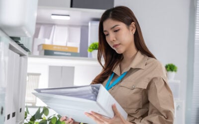Employee reviewing discipline records, workplace complaint notes, and termination documents after reporting gender discrimination.