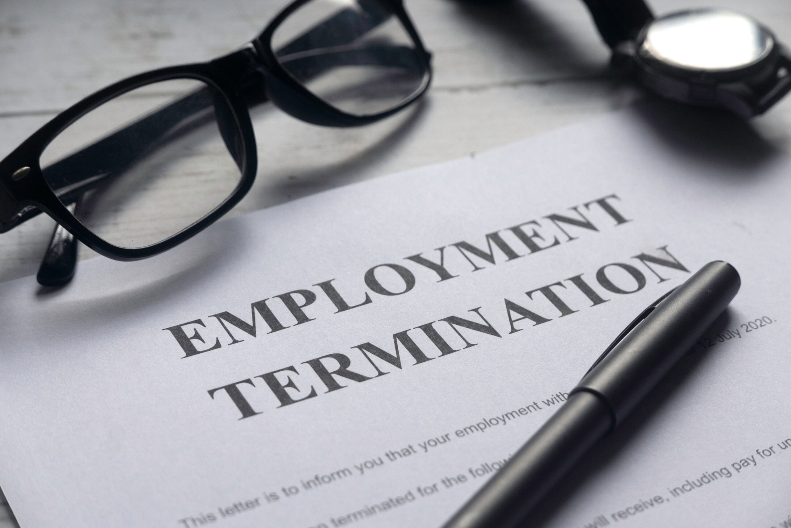 Wrongfully fired employee reviewing court papers without an employment lawyer.