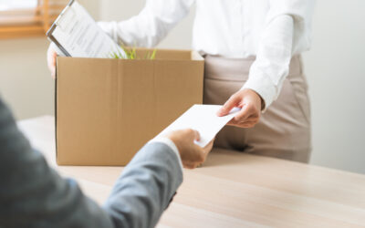 Employee packing personal belongings after being laid off during FMLA medical leave following a reduction in force.