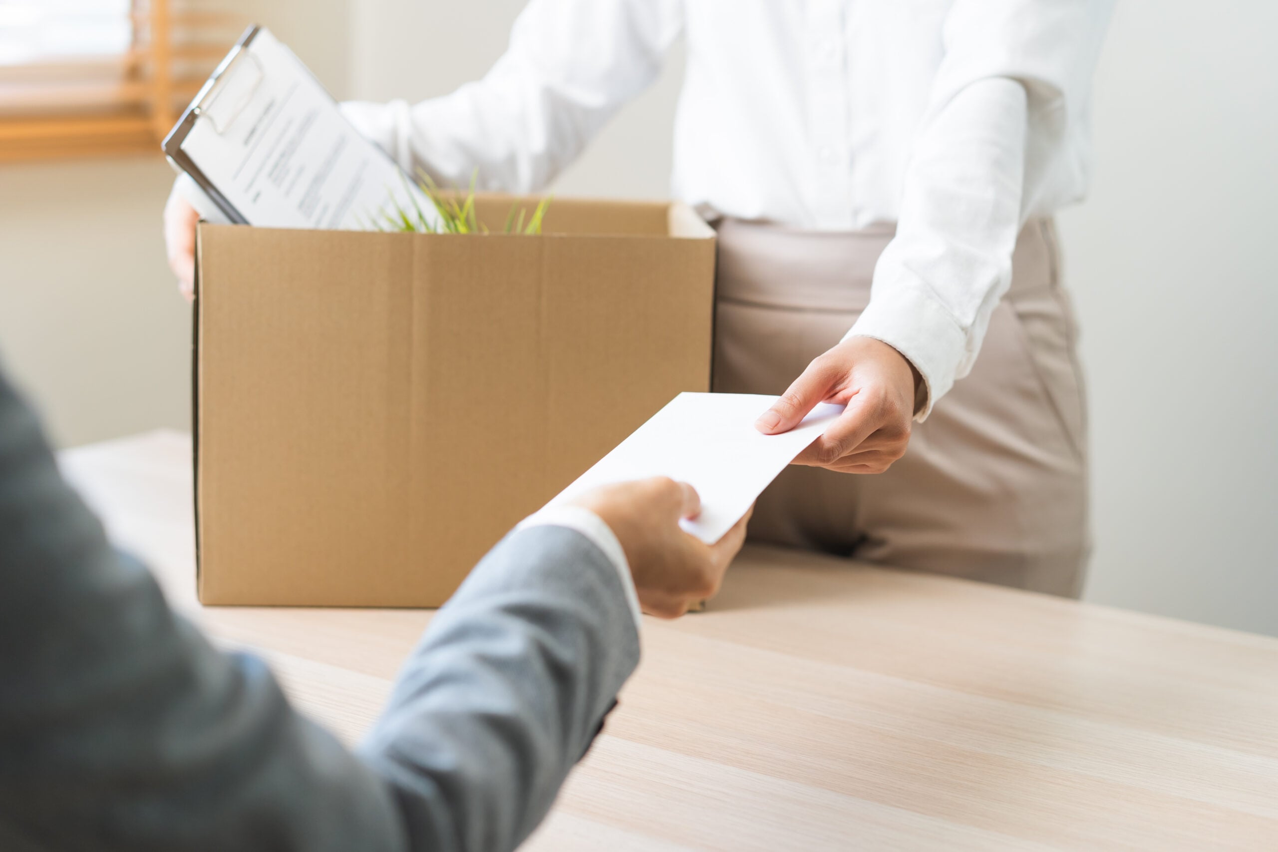 Employee packing personal belongings after being laid off during FMLA medical leave following a reduction in force.