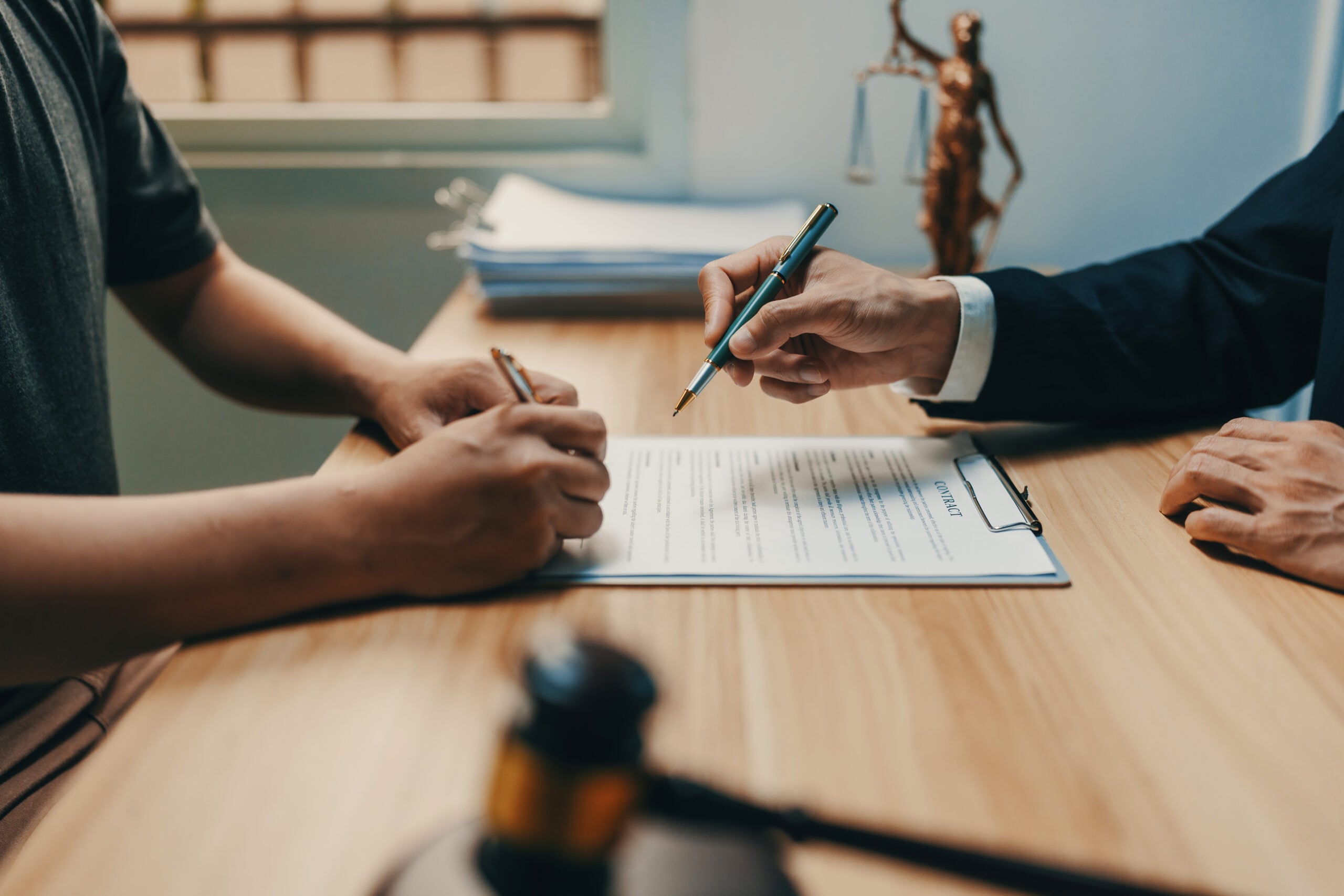Person reviewing a stack of court papers while handling a Title VII employment discrimination lawsuit without an employment lawyer.