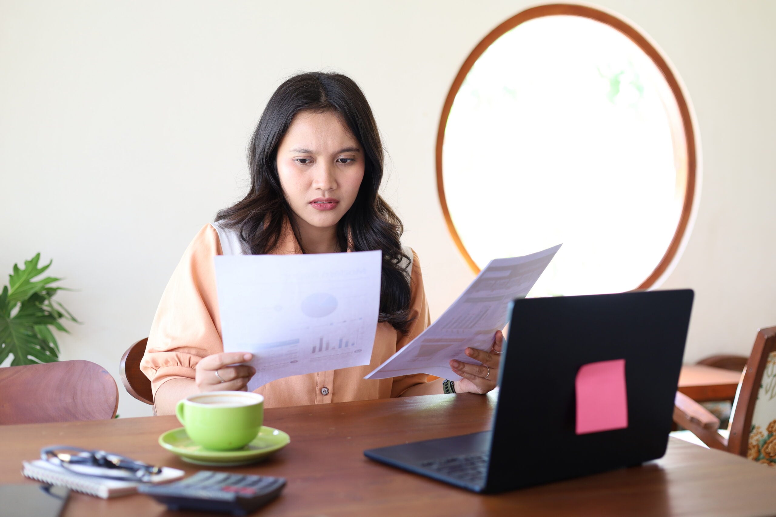 Employee reviewing invasive discovery requests, deposition papers, and documents in a wrongful termination and employment discrimination lawsuit.