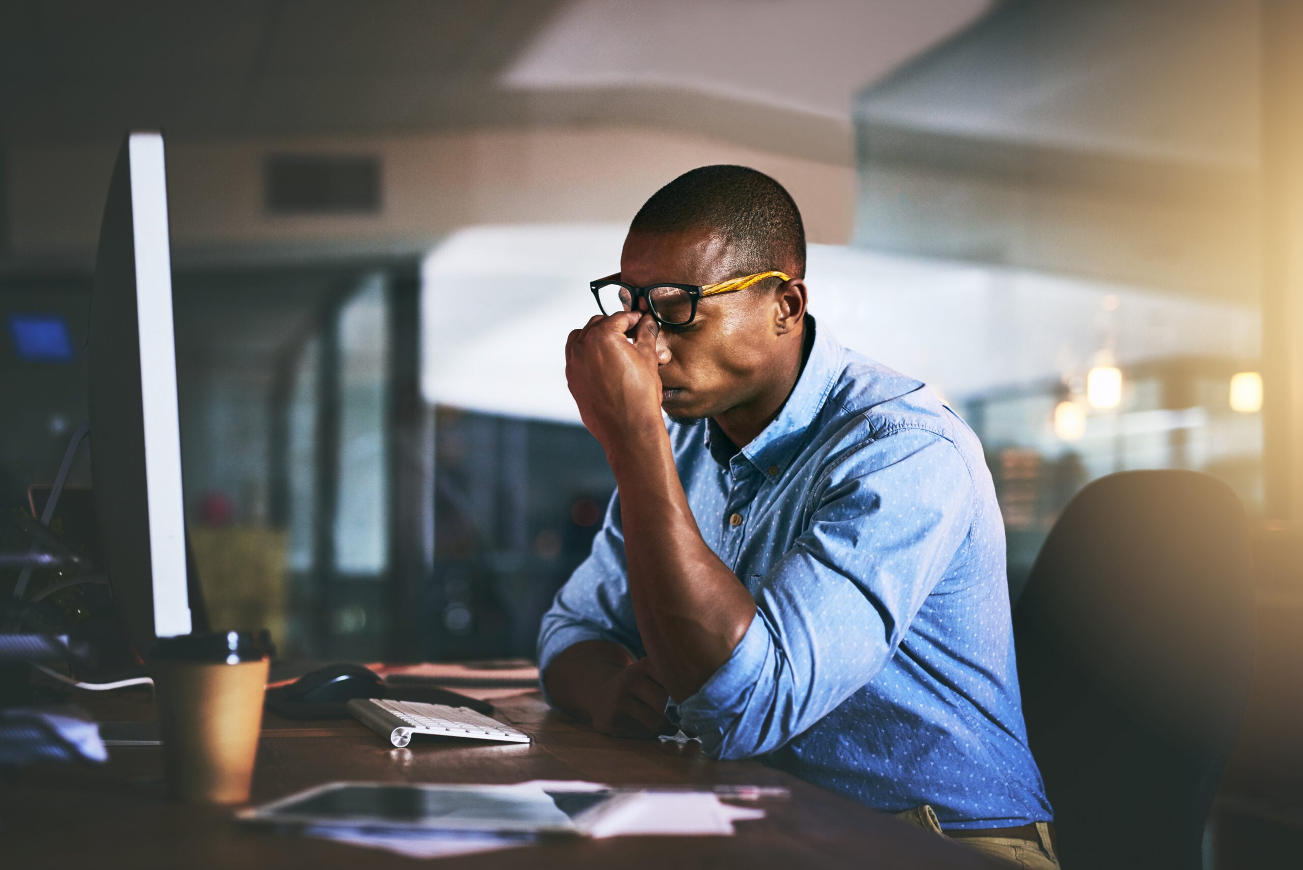 Black employee at an office desk reviewing a large race discrimination jury verdict and damages award.